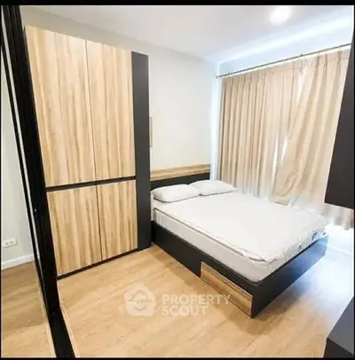 Modern bedroom with wooden flooring and sleek wardrobe design