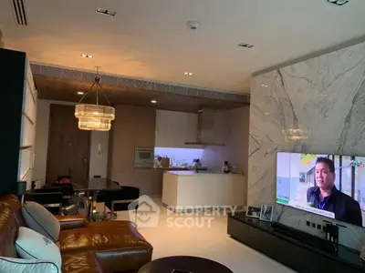 Luxurious open-layout living room with modern kitchen and elegant lighting