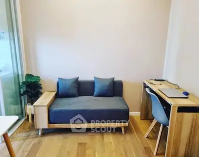 Modern study area with sleek desk and cozy sofa in a minimalist design.