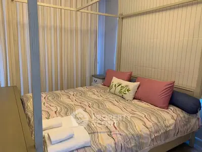 Cozy bedroom with stylish bedding and soft lighting, perfect for relaxation.