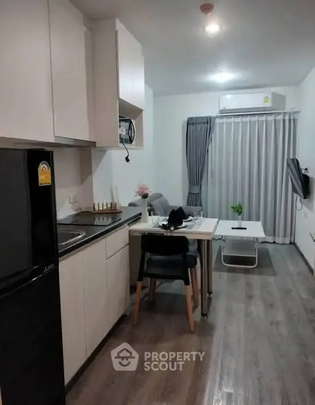 Modern compact kitchen and living area with sleek design and cozy ambiance.