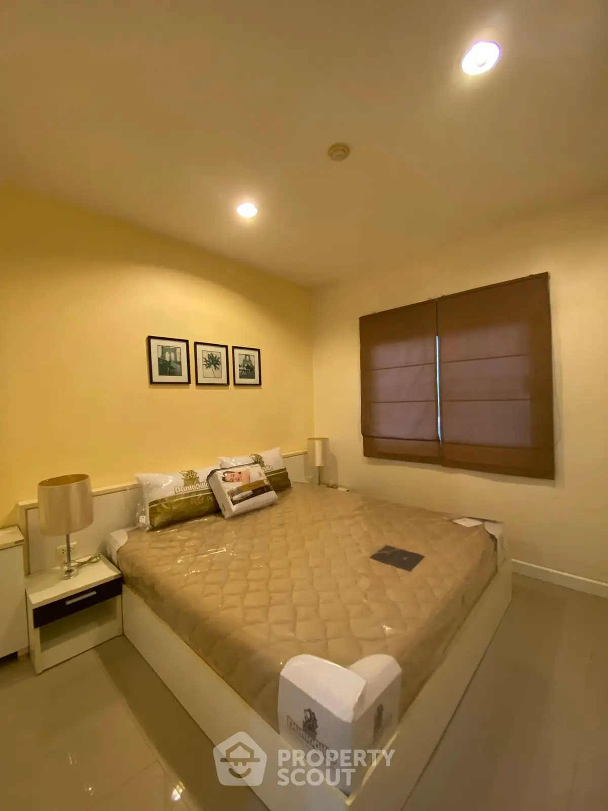 Cozy bedroom with modern decor and ambient lighting, perfect for relaxation.