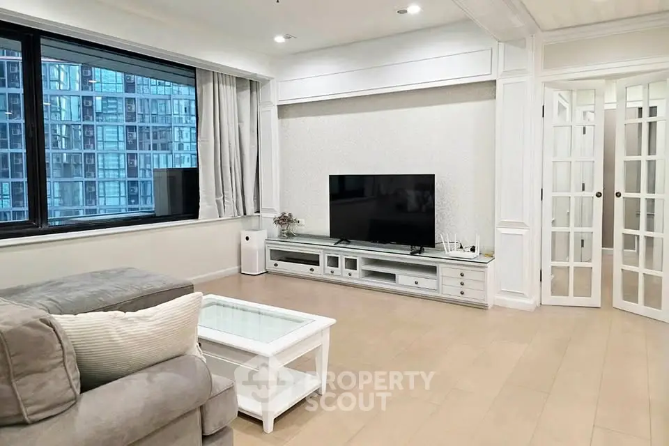 Spacious modern living room with large window and elegant decor