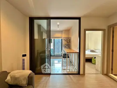 Modern apartment interior with sliding glass doors and cozy bedroom view