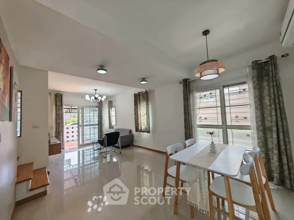 Spacious modern living and dining area with natural light and stylish decor