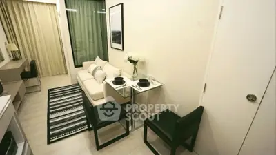 Modern living room with cozy sofa, dining table, and stylish decor in a compact apartment setting.