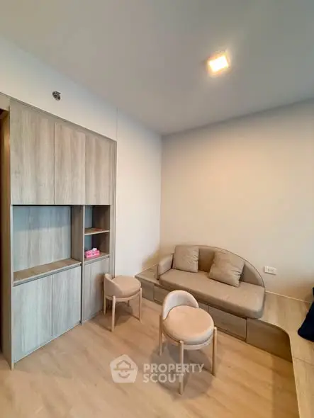Modern living room with stylish furniture and built-in storage, perfect for cozy urban living.