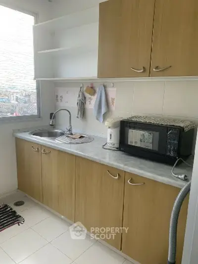 Charming kitchen with wooden cabinets and modern appliances, perfect for culinary enthusiasts.