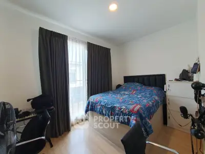 Cozy bedroom with modern decor and ample natural light