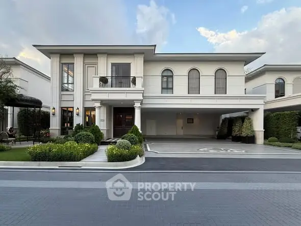 Luxurious modern house exterior with elegant landscaping and spacious driveway.