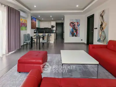 Spacious modern living room with red sofas and open kitchen layout