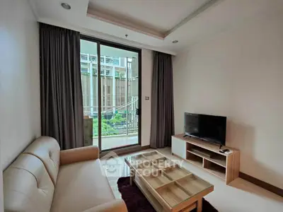Modern living room with sleek furniture and large window overlooking a garden view.