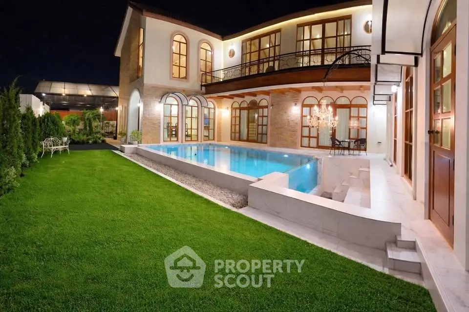 Luxurious villa with stunning pool and lush garden at night
