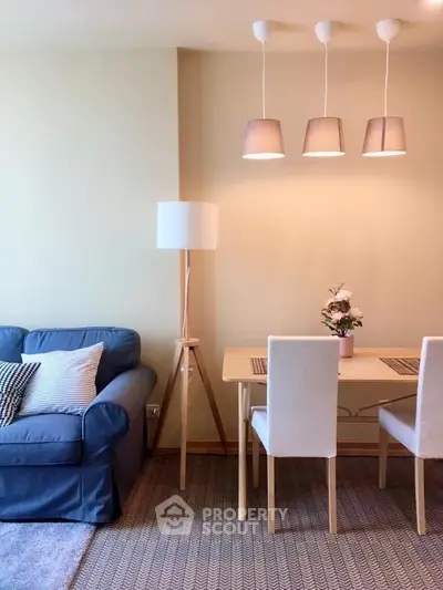 Cozy living room with stylish dining area and modern lighting