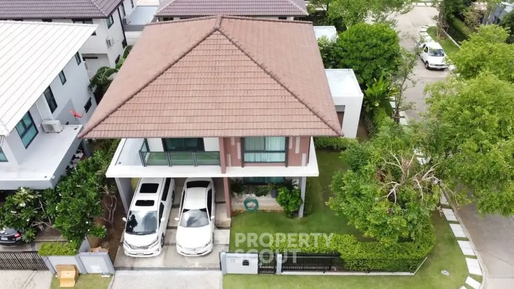 Charming two-story house with spacious driveway and lush garden in a serene neighborhood.