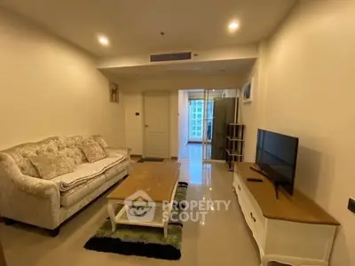 Spacious living room with elegant furniture and modern decor in a high-rise apartment.