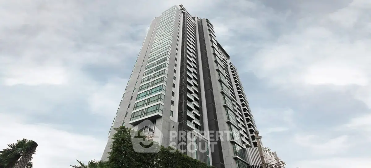 Stunning high-rise building with modern architecture and lush greenery, perfect for urban living.