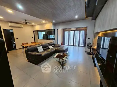 Spacious modern living room with sleek design and large windows for natural light.