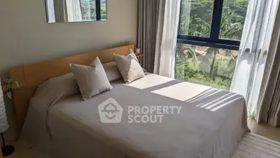 Bright bedroom with large window and scenic view, featuring a cozy bed and elegant decor.