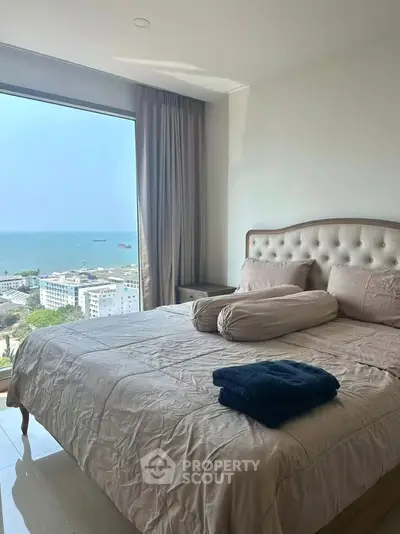 Luxurious bedroom with stunning ocean view and elegant decor, perfect for relaxation and comfort.