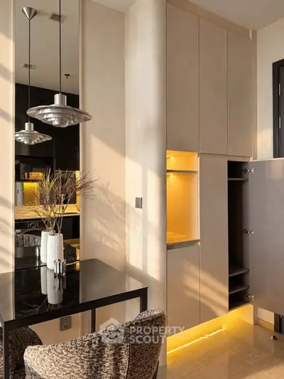 Modern kitchen with sleek cabinetry and elegant lighting in a stylish apartment.