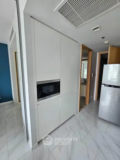 Modern kitchen with sleek cabinetry and built-in appliances in a stylish apartment.