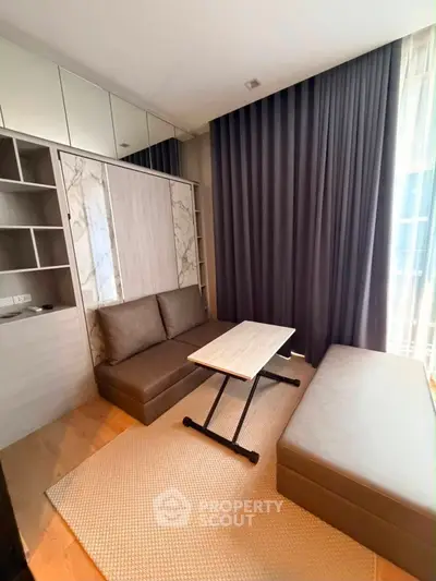 Modern living room with stylish furniture and floor-to-ceiling curtains in a cozy apartment.