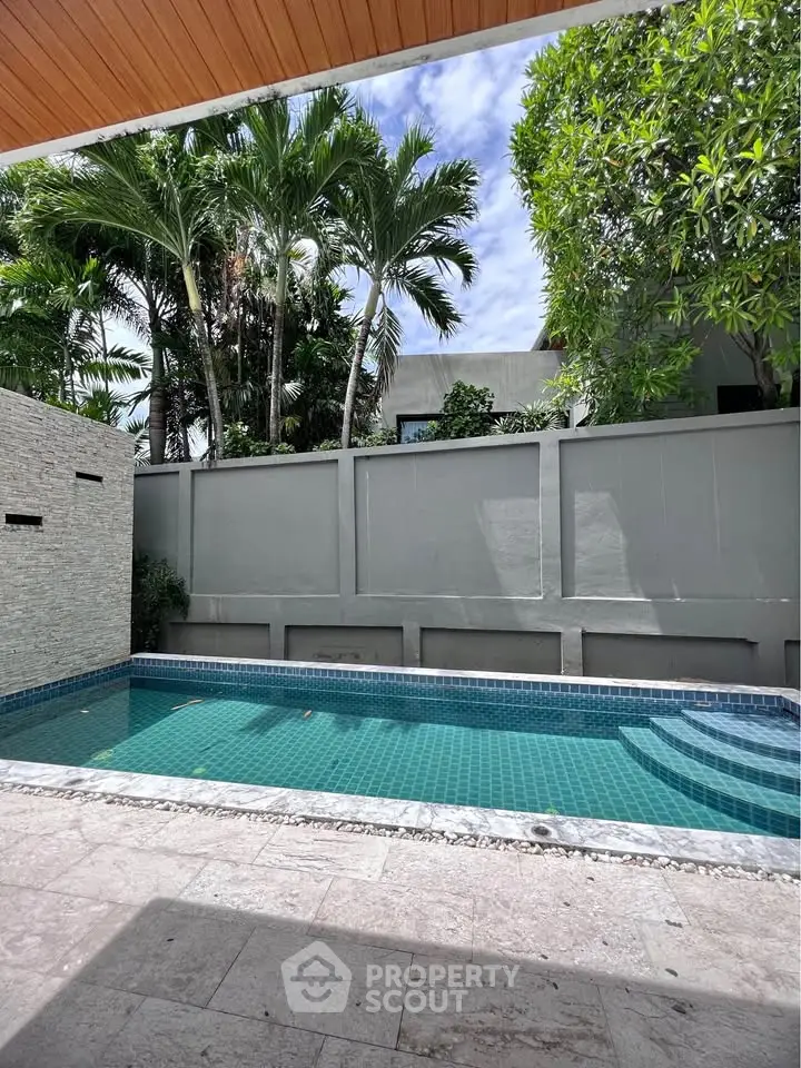 Luxurious private pool surrounded by lush greenery in modern villa