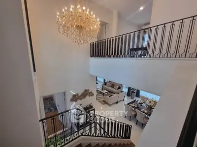 Luxurious two-story living room with elegant chandelier and modern decor