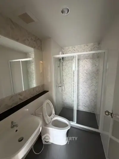 Modern bathroom with glass shower and sleek fixtures