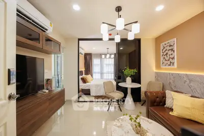 Modern living room with stylish decor and open view to cozy bedroom