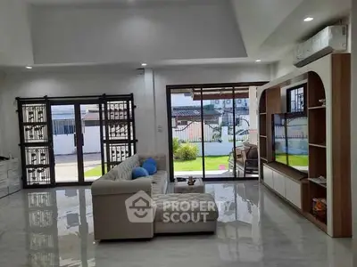 Spacious living room with modern decor and garden view