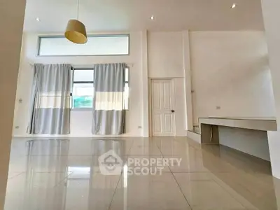 Spacious modern living room with high ceilings and large windows