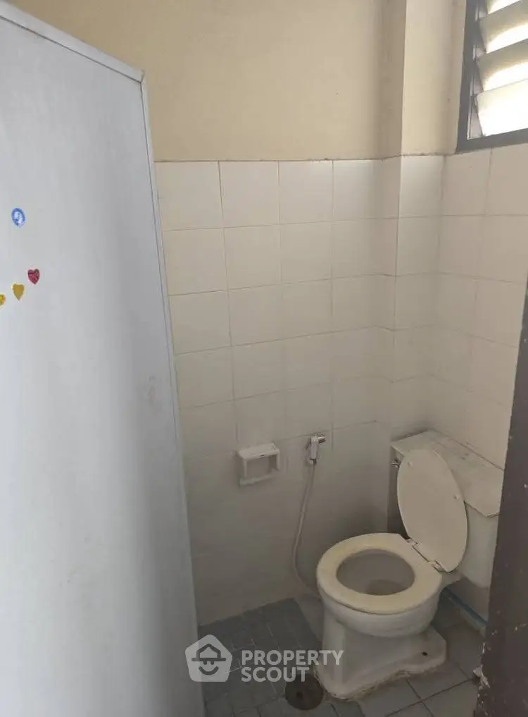 Simple bathroom with white tiles and basic fixtures