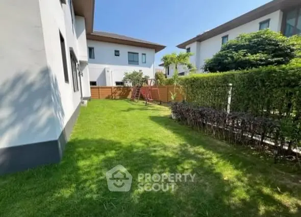 Spacious garden area in modern residential neighborhood with lush greenery.