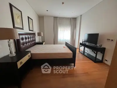Spacious bedroom with modern furniture and natural light