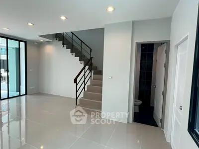 Modern interior with sleek staircase and tiled flooring, perfect for contemporary living.