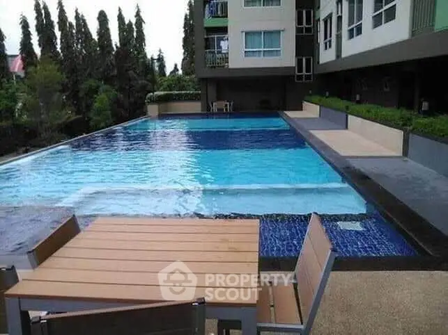 Luxurious apartment complex with stunning poolside view and modern amenities.