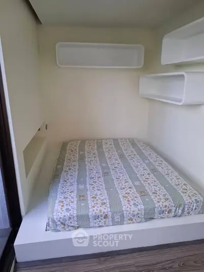 Cozy built-in bed nook with modern shelving in minimalist design