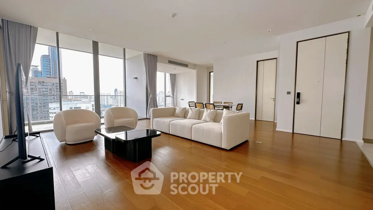 Spacious modern living room with city view and elegant furnishings.