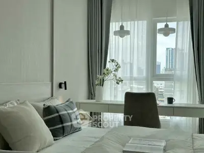 Modern bedroom with city view, featuring elegant decor and natural light.