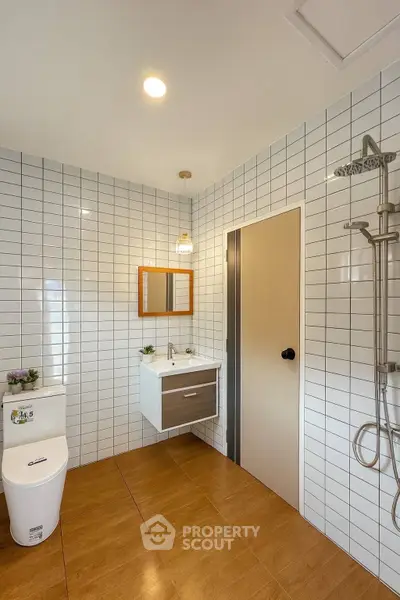 Modern bathroom with sleek fixtures and white tiled walls
