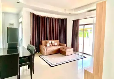 Spacious living room with modern furniture and large windows for natural light.