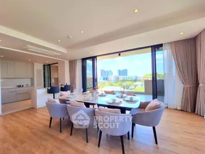 Luxurious open-plan living and dining area with stunning city views and elegant decor.