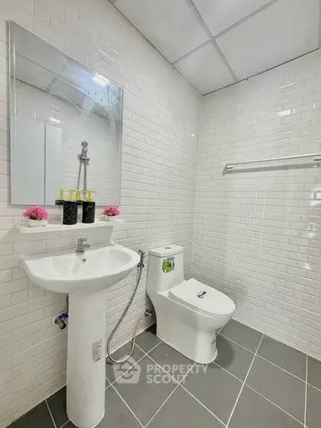 Modern bathroom with white subway tiles and sleek fixtures