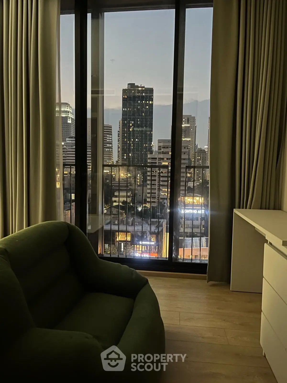 Luxurious high-rise apartment with stunning city view from the living room, featuring modern furnishings.