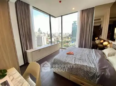 Luxurious bedroom with stunning city view and modern decor in high-rise apartment.