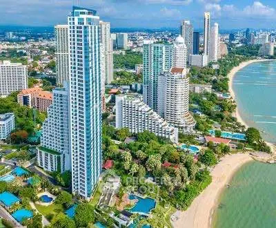 Stunning beachfront high-rise buildings with lush greenery and ocean views in a vibrant cityscape.