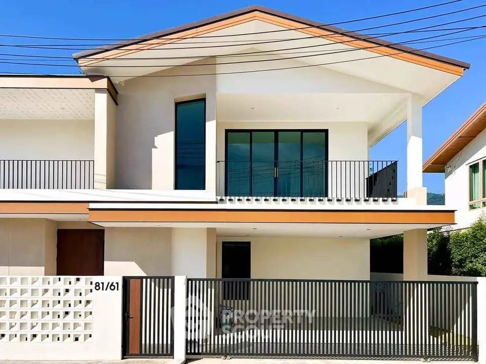Modern two-story house with sleek balcony and gated entrance
