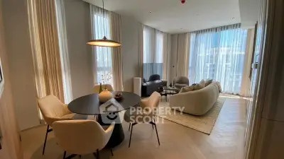 Elegant modern living room with dining area and large windows in luxury apartment.
